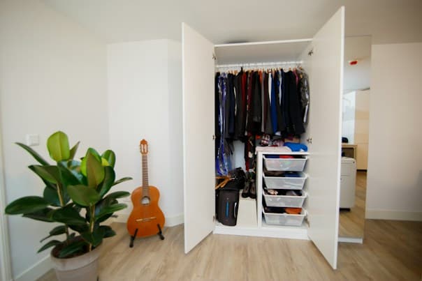 White hinged wardrobe in Sydney with hanging space and pull-out drawer storage