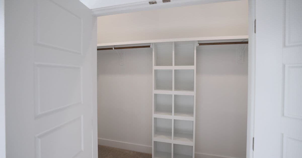 White reach-in wardrobe with hanging rails and cubby shelves in Sydney