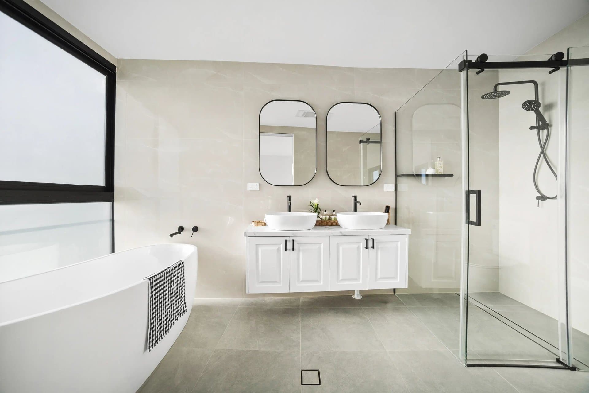 Sydney bathroom with a double vanity and refined tiled finishes