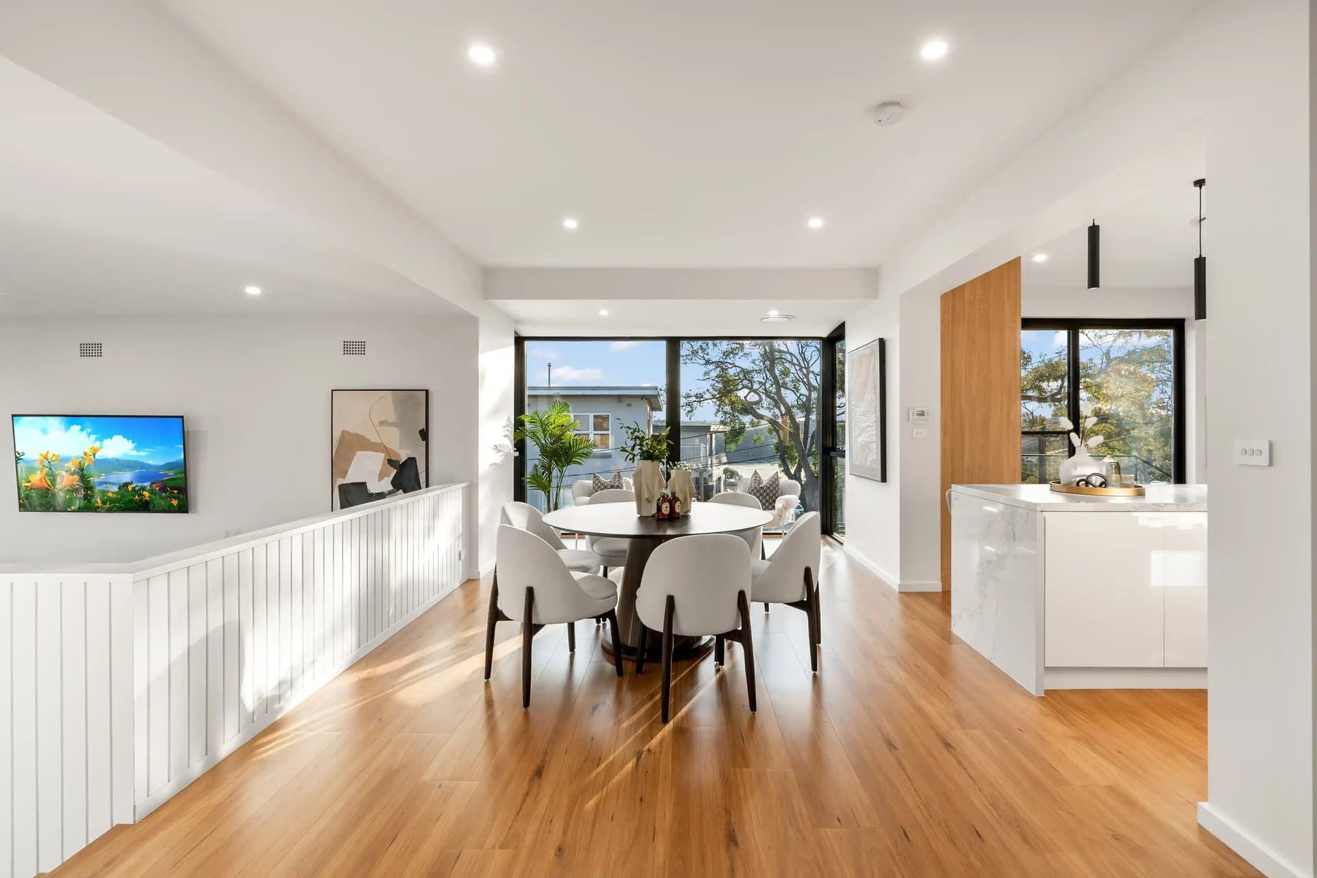 Warm oak flooring through a Sydney dining room