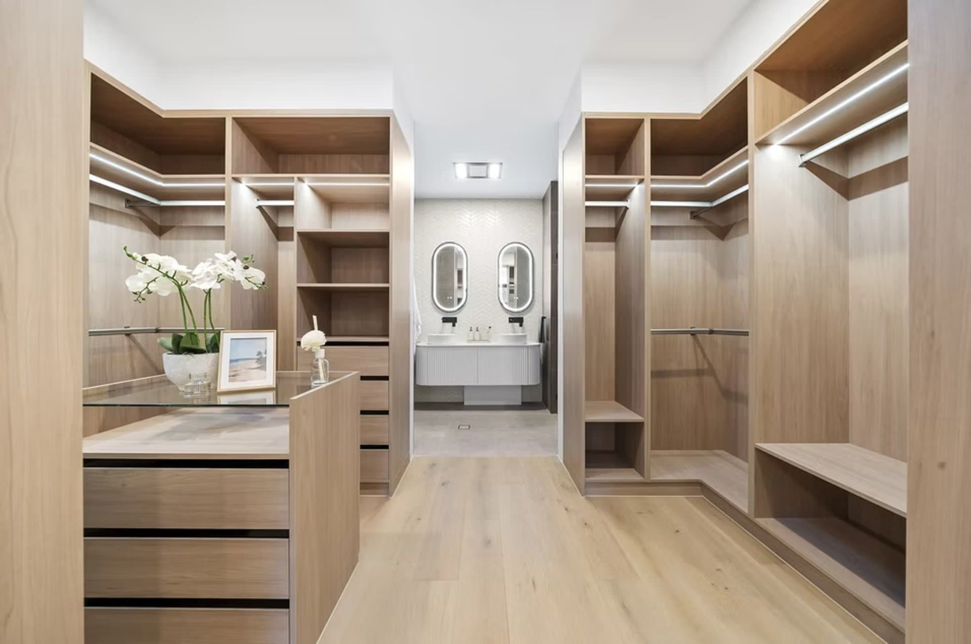 Walk-in oak wardrobe with island storage in Sydney